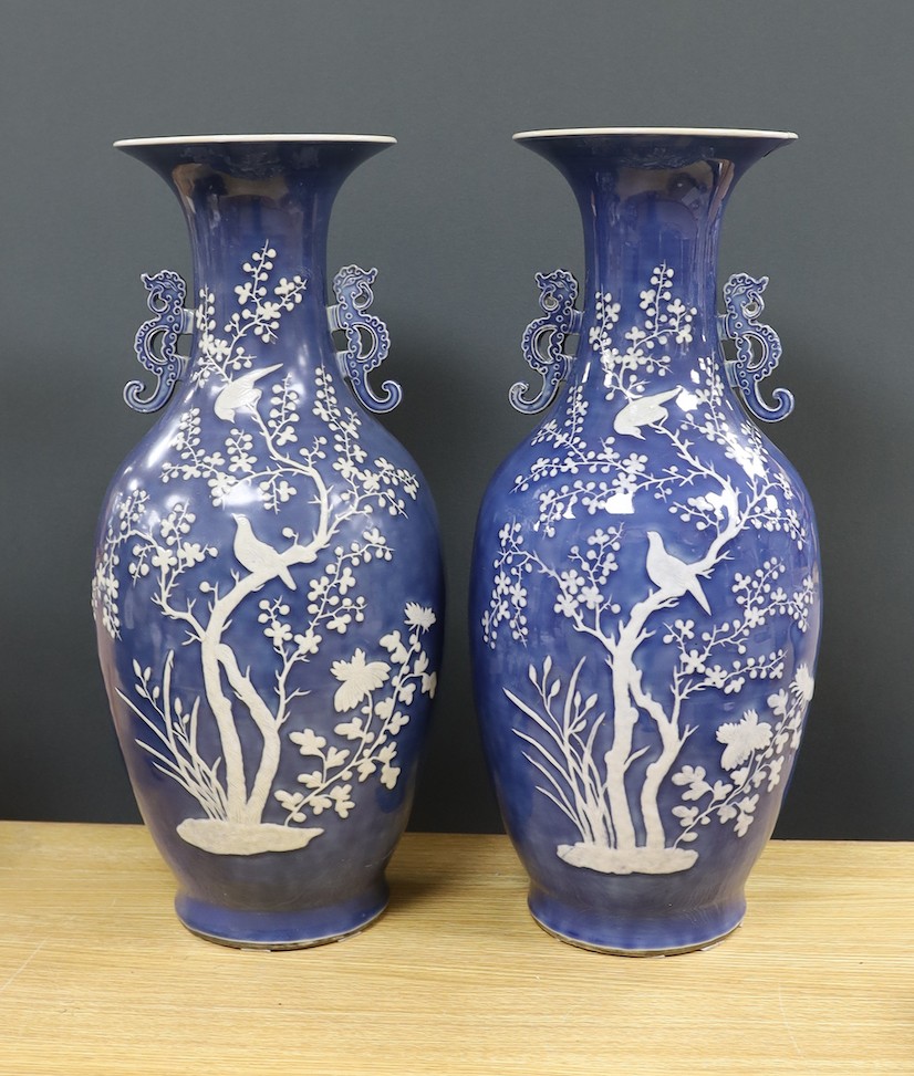 A pair of large 19th century Chinese slip decorated blue ground vases, restored, 59cm